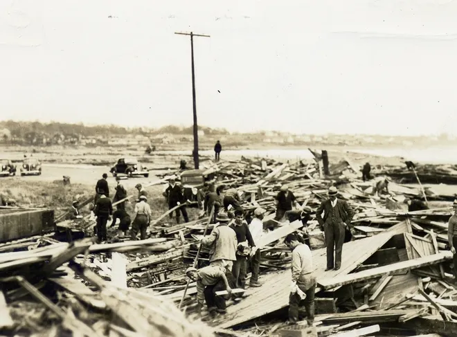 People examining damages after "The Long Island Express" hurricane